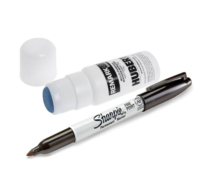 Writing supplies for write-on name tags, including a black Sharpie marker and marker remover stick