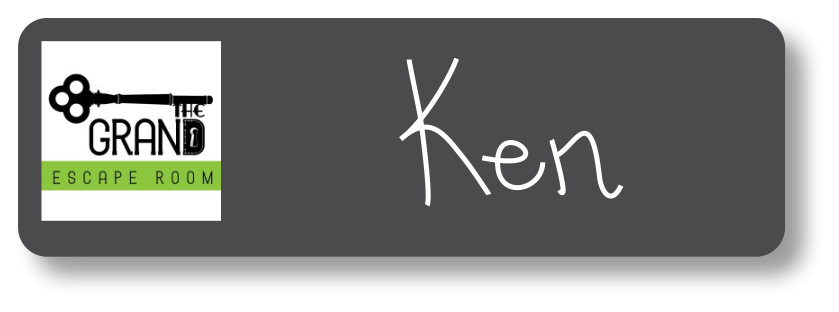 Black chalkboard rectangle name tag with the name Ken on it